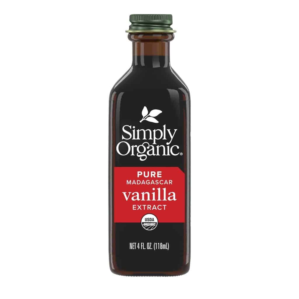 A glass bottle of Simply Organic Pure Madagascar Vanilla Extract with a green cap, featuring a red label and white text. Perfect for adding rich flavor to your chocolate covered quinoa recipe. This 4 fl oz (118 ml) bottle displays the USDA organic seal.