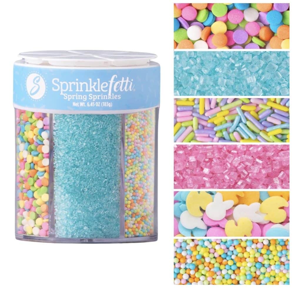 A container of Sprinklefetti Spring Sprinkles with six sections, perfect for decorating your Easter bundt cake. Each section is filled with colorful sprinkles—circles, rods, bunnies, and sugar crystals in lovely pastel colors.