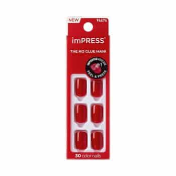 A package of imPRESS press-on nails in a bright red color. The package contains 30 nails, is labeled "The No Glue Mani," and features a "Peel & Press" application. The packaging is mostly red with clear windows.