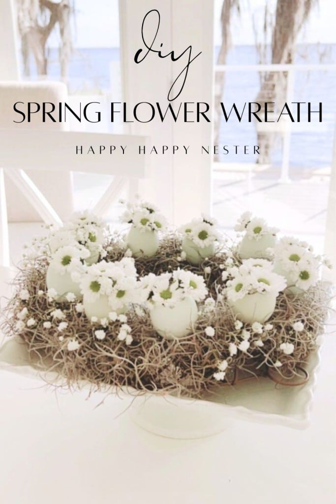 A charming spring flower wreath DIY featuring white eggshells filled with tiny blooms, arranged with twigs and delicate greenery in a circle on a white stand; text reads "DIY Spring Flower Wreath".