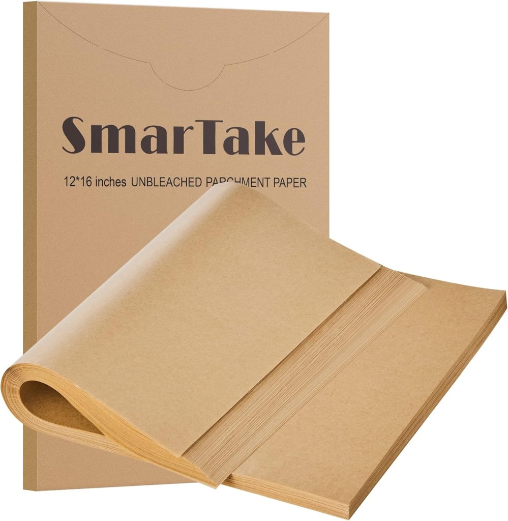 A package labeled “SmarTake 12*16 inches UNBLEACHED PARCHMENT PAPER” with several sheets of brown parchment paper fanned out in front—perfect for your next meringue cookies recipe.