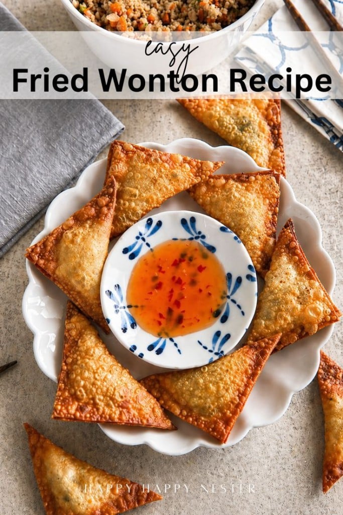 A white plate holds several crispy wontons arranged around a small dish of sweet chili sauce. Part of a bowl with filling and a blue napkin are visible nearby. Text reads "Easy Fried Wonton Recipe"—the perfect fried wonton recipe for any occasion.