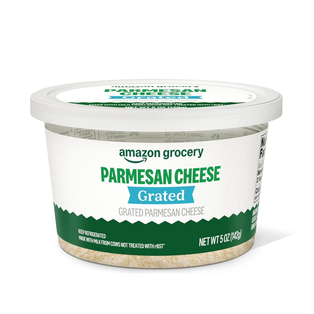 A 5-ounce plastic tub of Amazon Grocery Grated Parmesan Cheese with a white lid and green-blue label—perfect for topping onion ring pizza. The label notes it’s made with milk from cows not treated with rBST.