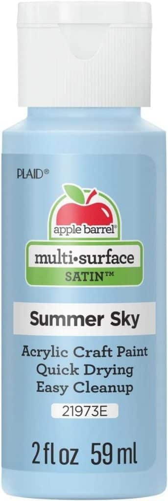 A bottle of Apple Barrel multi-surface satin acrylic craft paint in "Summer Sky”—ideal for oyster shell wreath DIY—featuring a blue label, white cap, and text describing it as quick-drying and easy to clean. Size: 2 fl oz (59 ml).