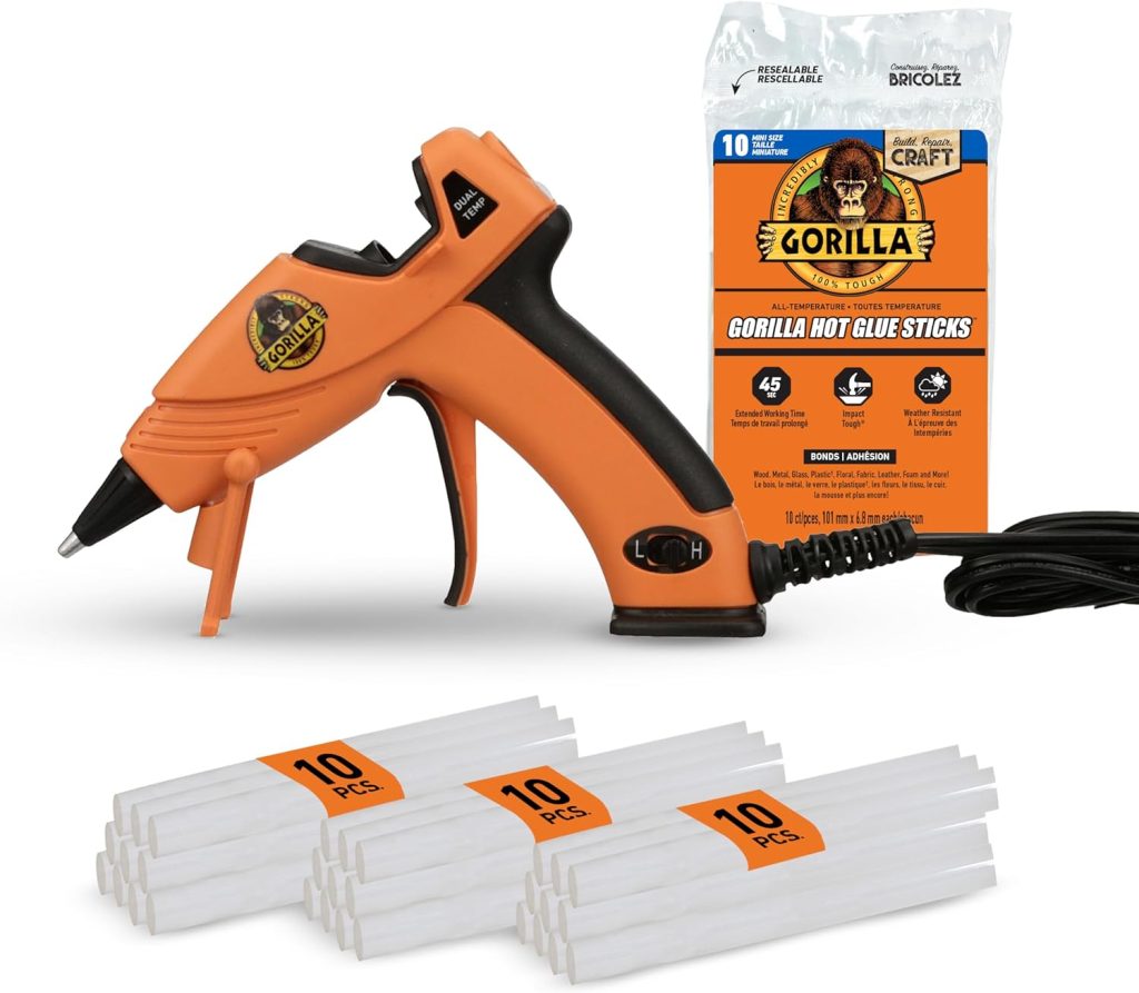 An orange Gorilla hot glue gun with black accents is shown, ideal for oyster shell wreath DIY projects, accompanied by five bundles of 10 white glue sticks each and a package labeled "Gorilla Hot Glue Sticks" for craft use.