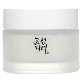 A frosted glass jar with a white lid featuring black Korean text on the front, containing a cosmetic or skincare product.