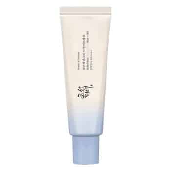 A gradient blue-and-white cosmetic tube with Korean text and a blue cap, standing upright against a white background.