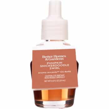 A small bottle of Better Homes & Gardens Pumpkin Snickerdoodle Swirl oil refill with a white cap and orange-brown label.
