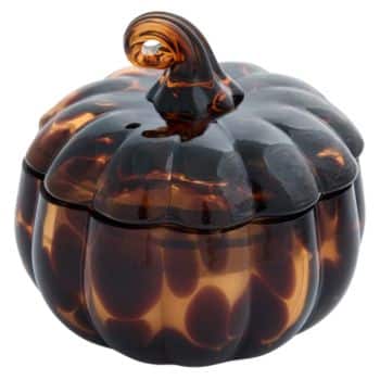 A small, pumpkin-shaped container made of glossy, tortoiseshell-patterned glass with a curved stem on top.