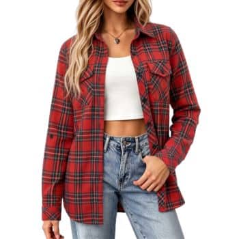 Woman wearing a red plaid shirt over a white crop top and blue jeans, with long wavy blonde hair and a necklace, standing against a white background.