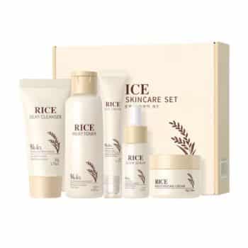 A set of five rice-based skincare products, including cleanser, toner, serum, eye cream, and moisturizing cream, displayed in front of a cream-colored box labeled “Rice Skincare Set.”.
