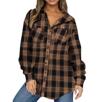Woman wearing an oversized brown and black plaid button-up shirt with front pockets, styled with blue jeans.