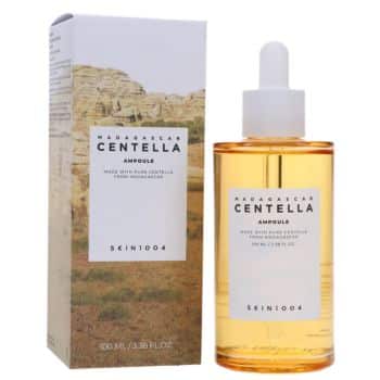 A bottle of SKIN1004 Madagascar Centella Ampoule with a dropper, shown next to its box featuring a landscape image and product details.