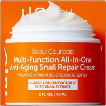 An orange jar of Seoul Ceuticals Multi-Function All-In-One Anti-Aging Snail Repair Cream, with white cream inside and text highlighting snail extract, vitamin E, B5, and organic green tea.
