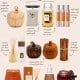 An assortment of fall-scented Walmart products including candles, diffusers, sprays, and decorative pumpkins, arranged on a beige background with handwritten notes describing each item&rsquo;s features and uses.