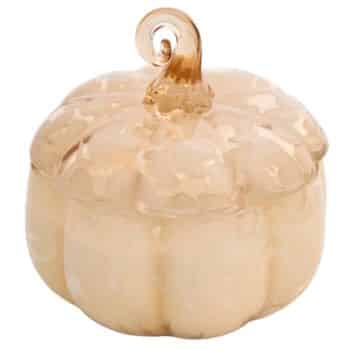 A decorative glass pumpkin container with a lid, featuring a light beige color and a glossy finish.