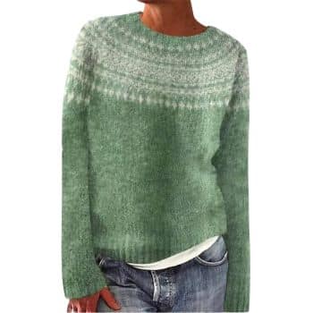 Person wearing a light green knit sweater with a white patterned yoke, paired with blue jeans and a white shirt underneath.