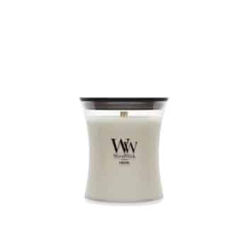 A white WoodWick candle in a curved glass container with a wooden lid, featuring the “WW WoodWick” logo on the front.