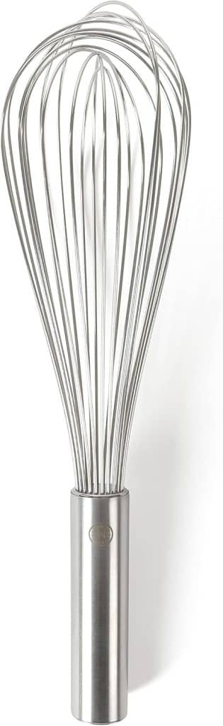 A stainless steel wire whisk with a cylindrical handle, photographed against a white background, perfect for mixing ingredients like pumpkin overnight oats.