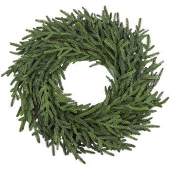 A circular wreath made of green pine branches, arranged densely with the tips pointing outward, against a white background.