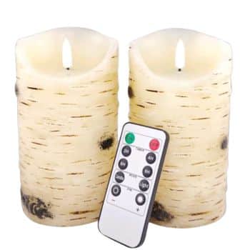 Set of two ivory birch bark flameless LED pillar candles with glowing flames and remote control.