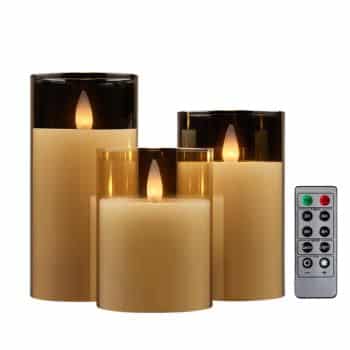 Three ivory flameless pillar candles inside clear glass holders with flickering flames and remote control.