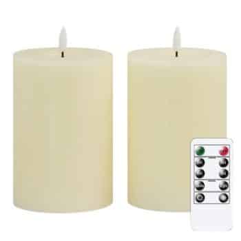 Two large ivory real wax flameless pillar candles with realistic LED flames and remote control.