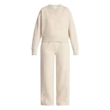 A matching cream-colored sweatshirt and sweatpants set, displayed on a plain white background. The outfit appears soft and comfortable with a relaxed fit.