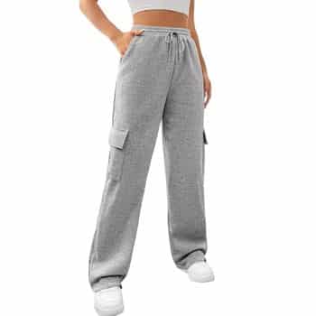 Person wearing high-waisted gray cargo sweatpants with side pockets and a drawstring, paired with a white crop top and white sneakers. Only the lower half of the body is visible.