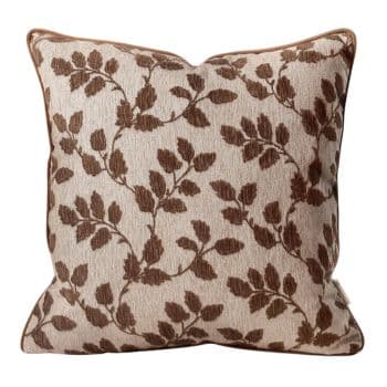 Cream chenille throw pillow with a textured brown leaf and vine pattern and brown piping.