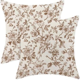 Cream throw pillow covers with an all-over vintage brown floral pattern.