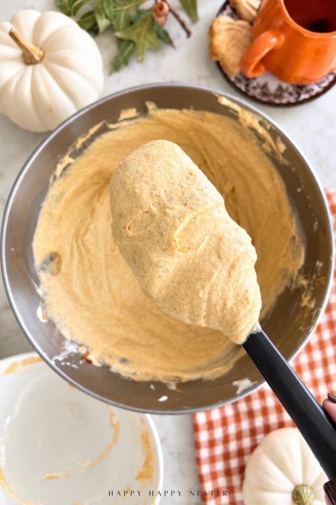 Thick and creamy no bake pumpkin cheesecake filling on a spatula showing the finished texture.