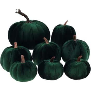 Set of dark emerald green velvet pumpkins in assorted sizes with natural-looking brown stems.