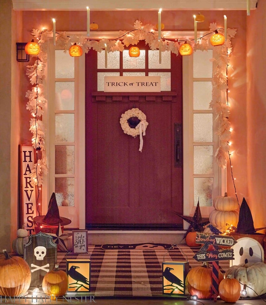 Glowing floating jack-o'-lanterns and candles above a Halloween porch, one of my favorite cute Halloween ideas.
