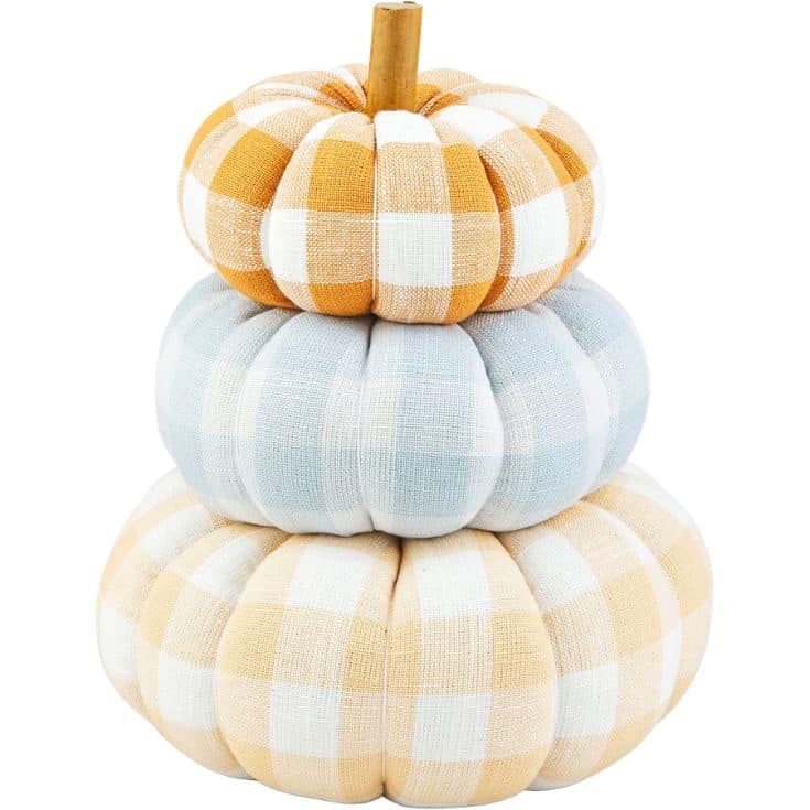 Three plaid fabric pumpkins stacked on top of each other: orange and white on top, blue and white in the middle, and beige and white on the bottom, with a short brown stem at the very top.