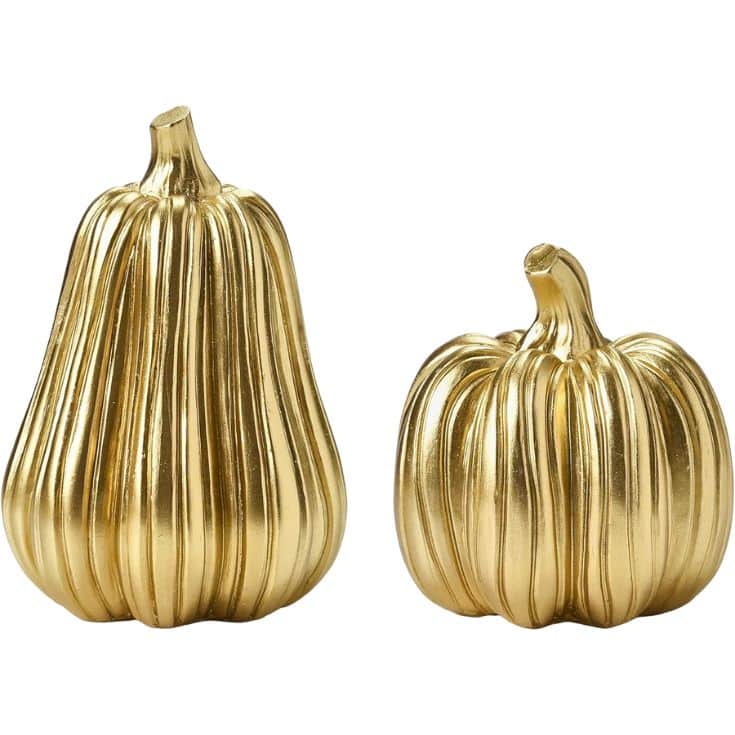 Two gold metallic decorative gourds, one taller and elongated, the other shorter and round, both with vertical ridges and short stems, displayed side by side on a white background.