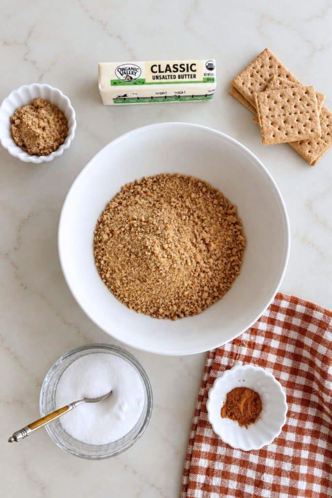 Graham cracker crumbs, butter, brown sugar, cinnamon, and salt for a no bake pumpkin cheesecake crust.