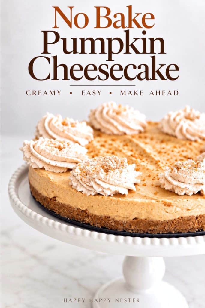 No Bake Pumpkin Cheesecake with a graham cracker crust and cinnamon whipped cream topping on a white cake stand.