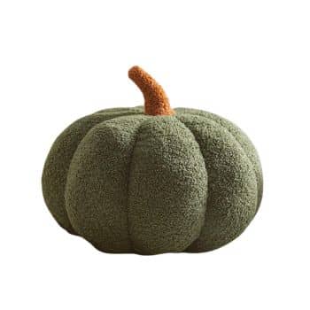 Olive green sherpa pumpkin with a soft textured finish and brown stem styled on a cream sofa for fall.
