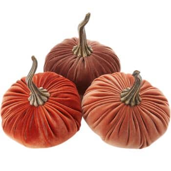 Set of three velvet pumpkins in rust, burnt orange, and muted peach with antique gold stems.