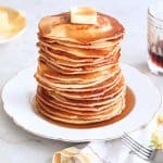 Pancakes from scratch stacked with butter and maple syrup
