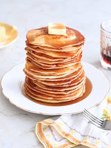 Pancakes from scratch stacked with butter and maple syrup