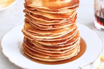 Pancakes from scratch stacked with butter and maple syrup
