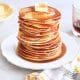 Pancakes from scratch stacked with butter and maple syrup