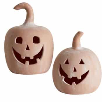Two distressed terracotta-colored jack-o'-lantern decorations with carved smiling faces.