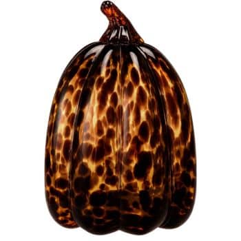 Amber and dark brown tortoiseshell glass pumpkin with a curved glass stem.
