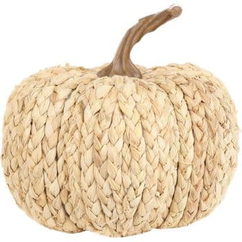 Natural woven corn husk pumpkin with braided texture and a curved brown stem.