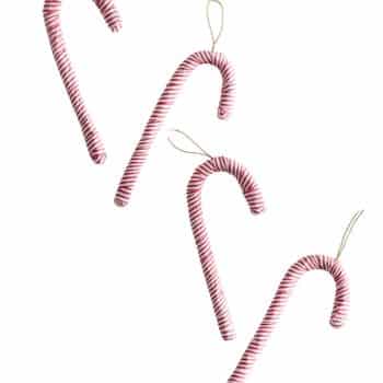 Four red and white striped candy cane Christmas ornaments with gold hanging loops.