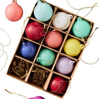 Colorful round glass Christmas ornaments in pink, blue, green, yellow, red, and lavender.