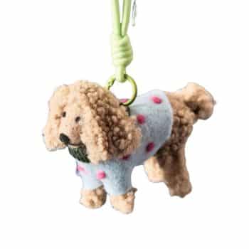 Felt dog Christmas ornament wearing a blue sweater with pink polka dots.